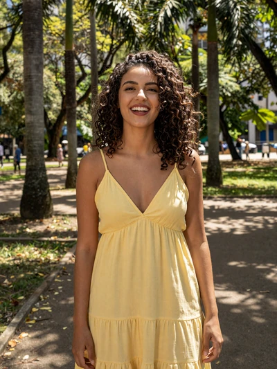 Isabela, 29, Brazilian woman in a yellow sundress at a São Paulo park